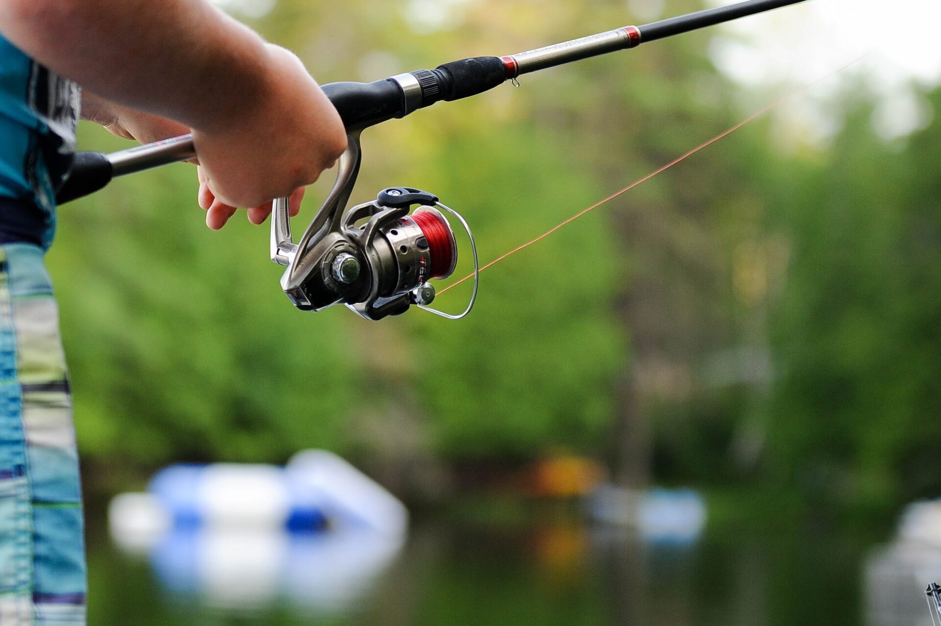 A close up view of a man holding a fishing rod