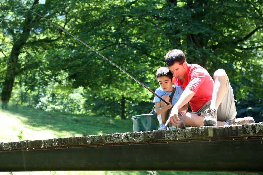 Father and so fishing on a dock