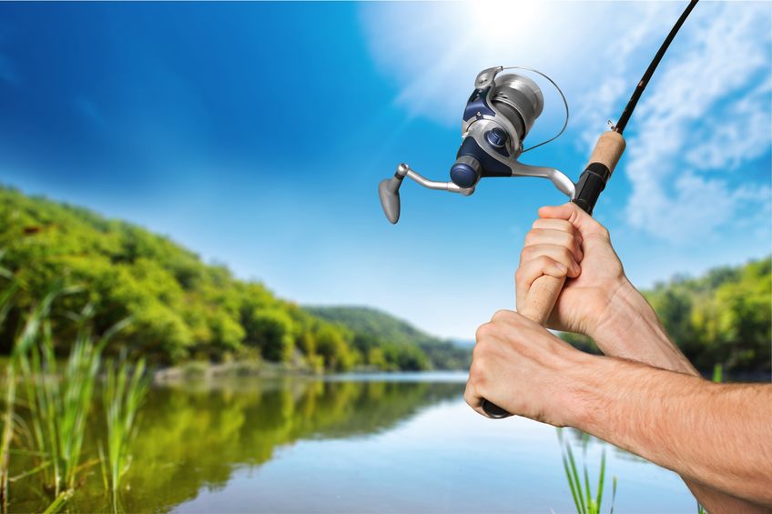 Closeup of Man Using New Fishing Rod