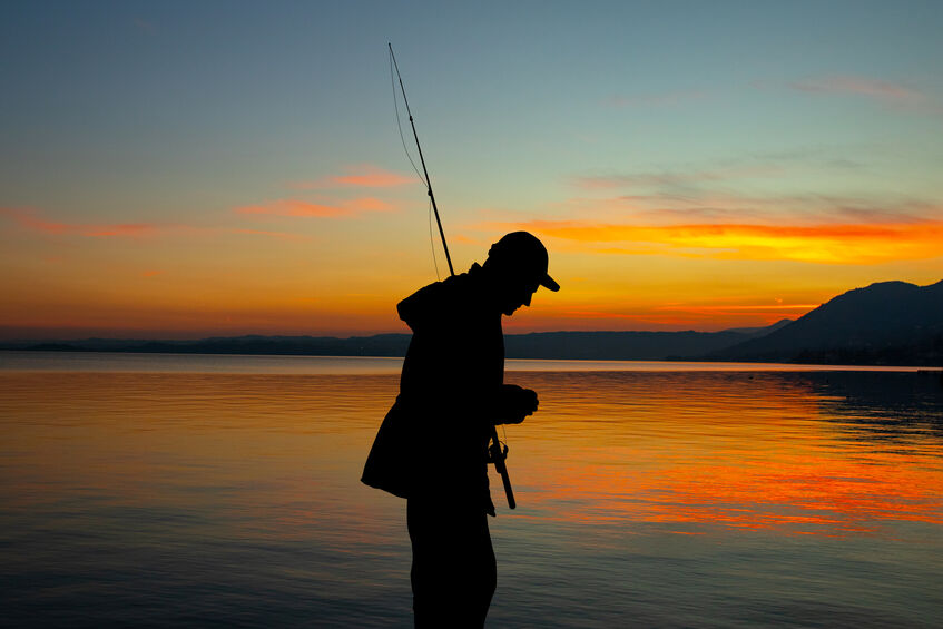 Man fishing at sunset