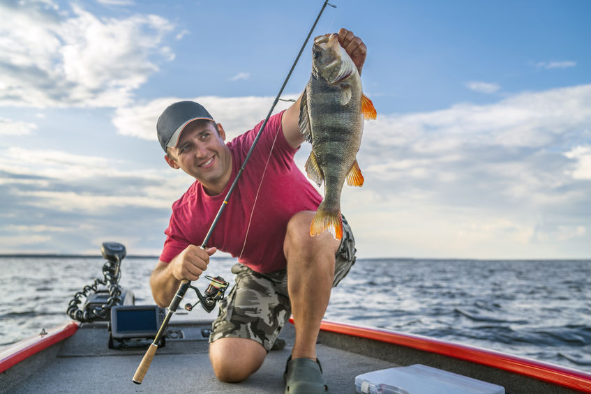 Fisherman on boat with fish