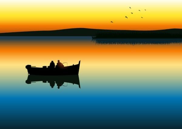 Two people fish in a small boat during a sunrise