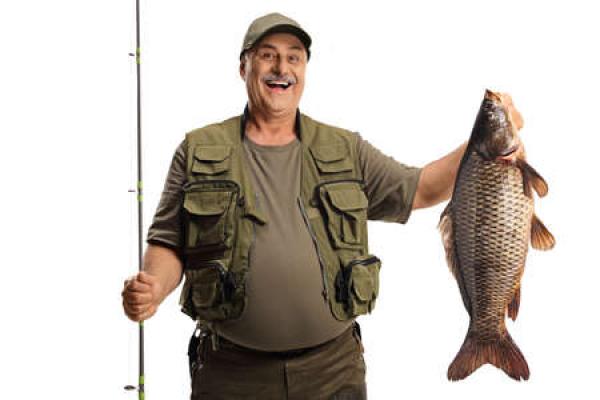 Man in fishing gear holds up a large carp